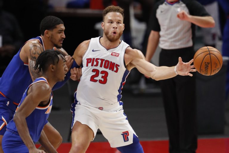 Dec 13, 2020; Detroit, Michigan, USA; Detroit Pistons forward Blake Griffin (23) passes the ball as he is covered by New York Knicks forward Obi Toppin (1) during the second quarter at Little Caesars Arena. Mandatory Credit: Raj Mehta-USA TODAY Sports
