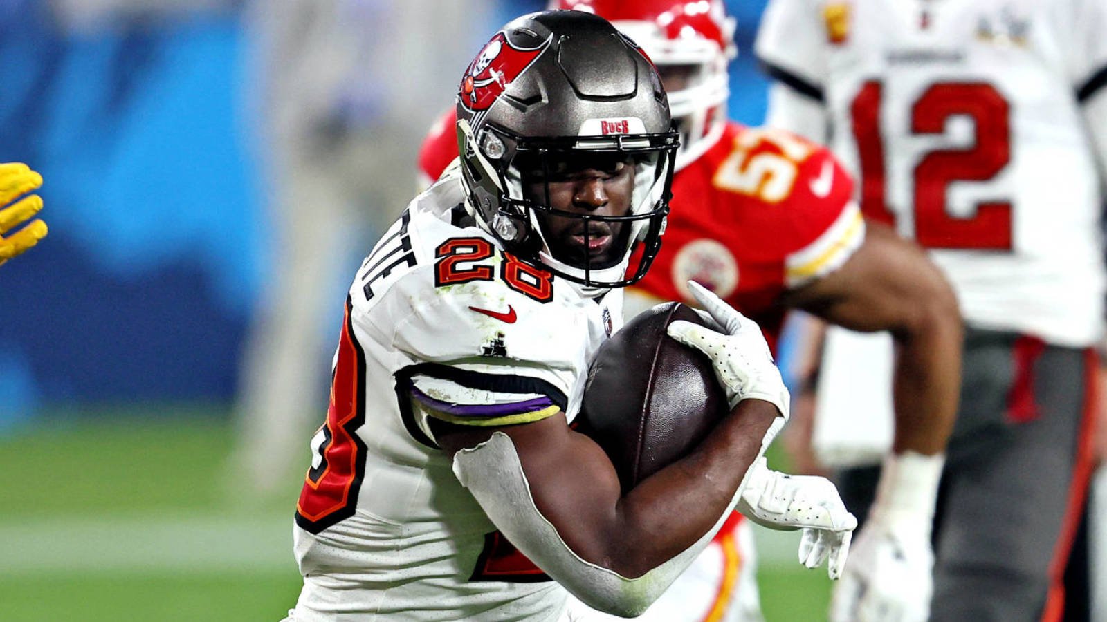 Feb 7, 2021; Tampa, FL, USA;  Tampa Bay Buccaneers running back Leonard Fournette (28) runs the ball against Kansas City Chiefs strong safety Tyrann Mathieu (32) during the fourth quarter in Super Bowl LV at Raymond James Stadium.  Mandatory Credit: Matthew Emmons-USA TODAY Sports